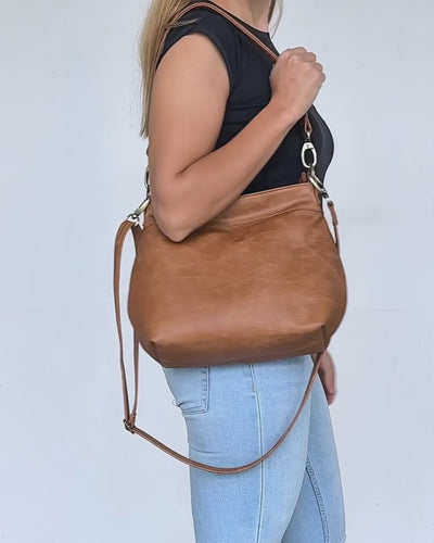 video of tan distressed small leather hobo bag