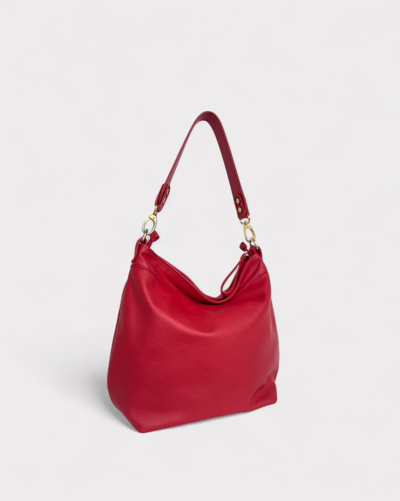 Red handbag with gold hardware on a light gray background