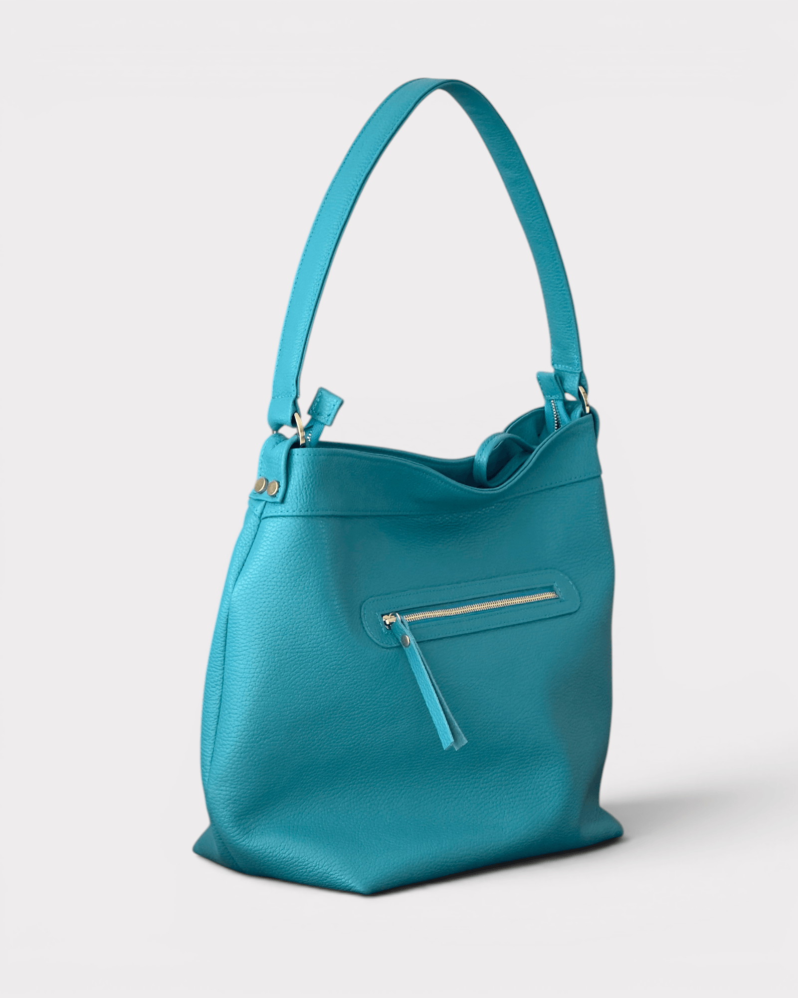 Turquoise handbag with a visible brand logo on a light gray background
