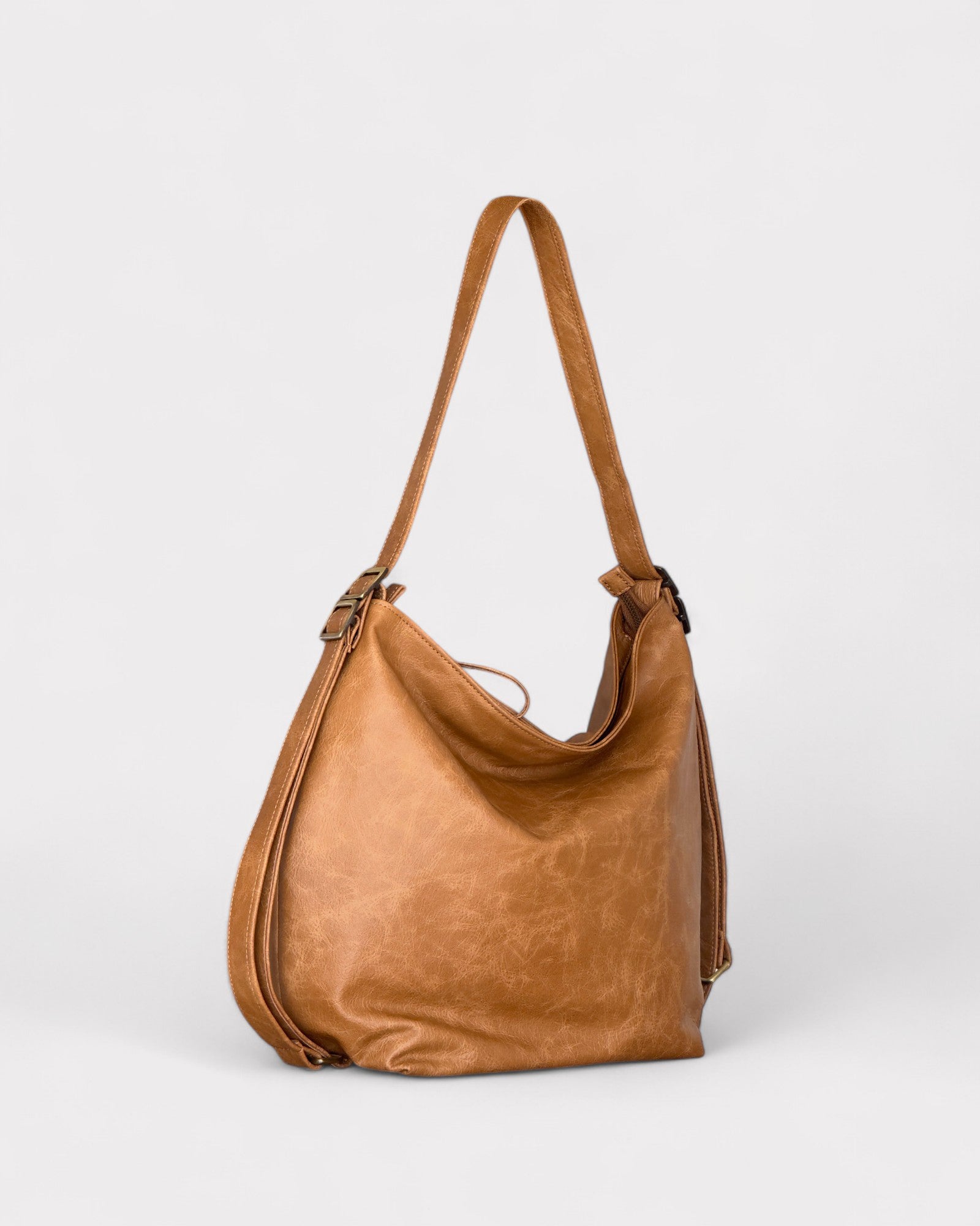Tan leather handbag on a light gray background