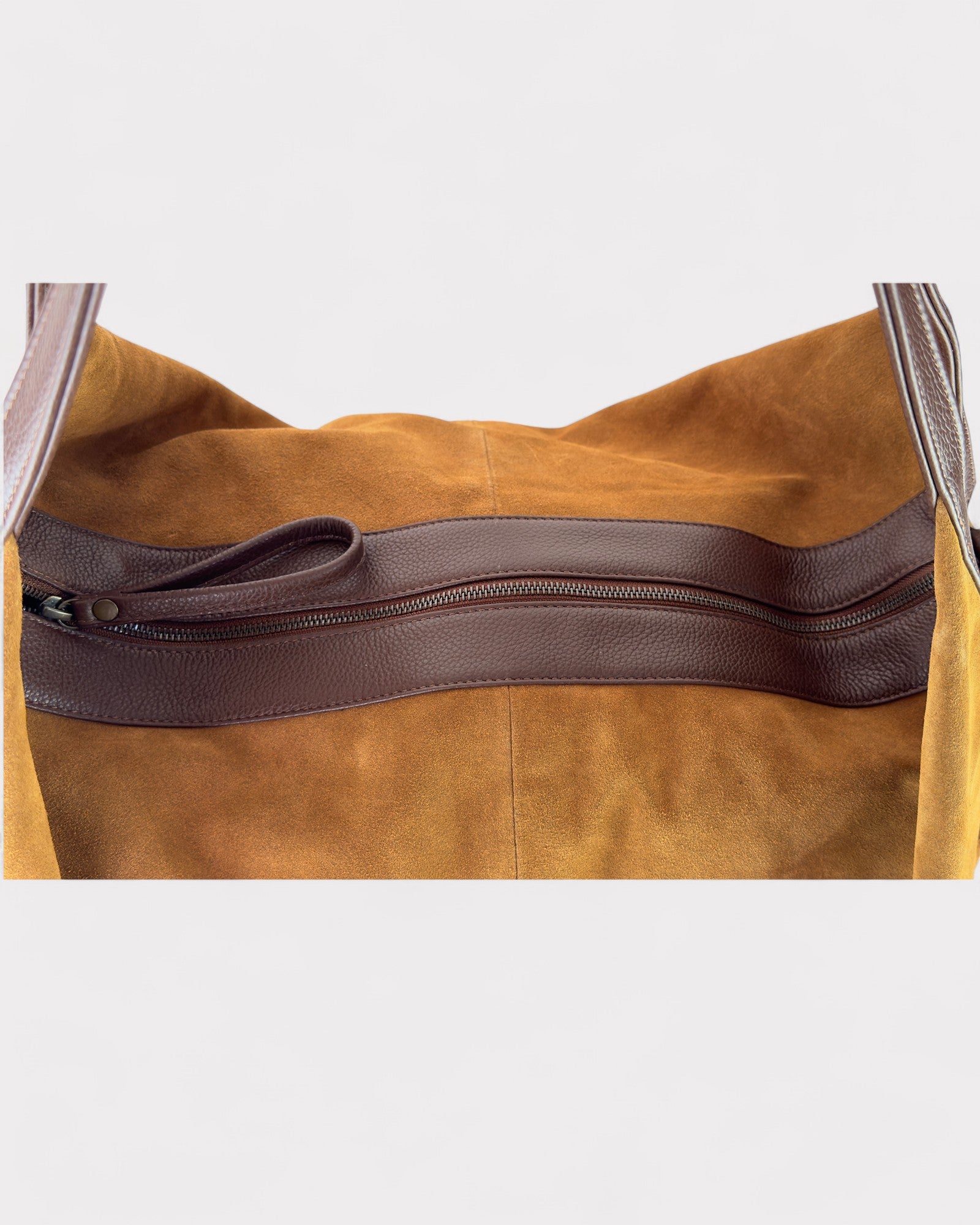 Tan leather bag with a zipper on a light gray background